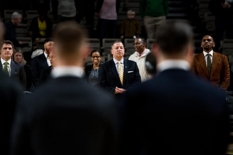 David Grace lines up with the coaching staff before tip-off against Buffalo.