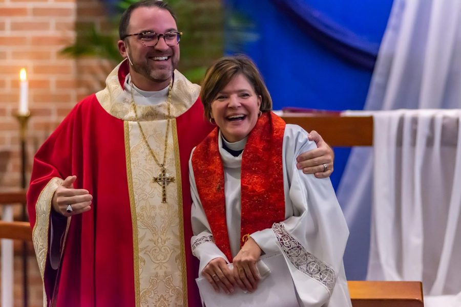 Lutheran has arms wrapped around Bennett in side hug as she gets ordained in ceremonial robes