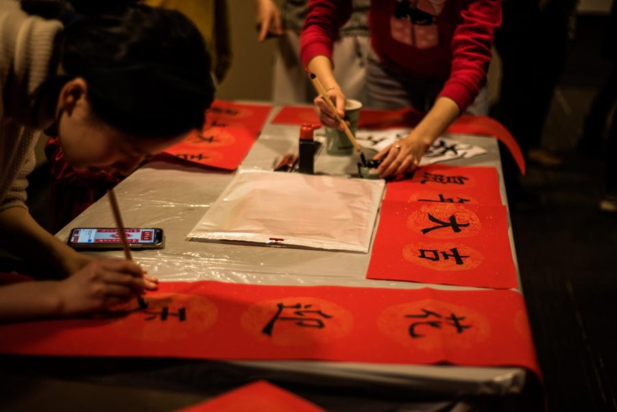 Students paint words of good luck at VUCA's Lunar New Year celebration Jan. 24.