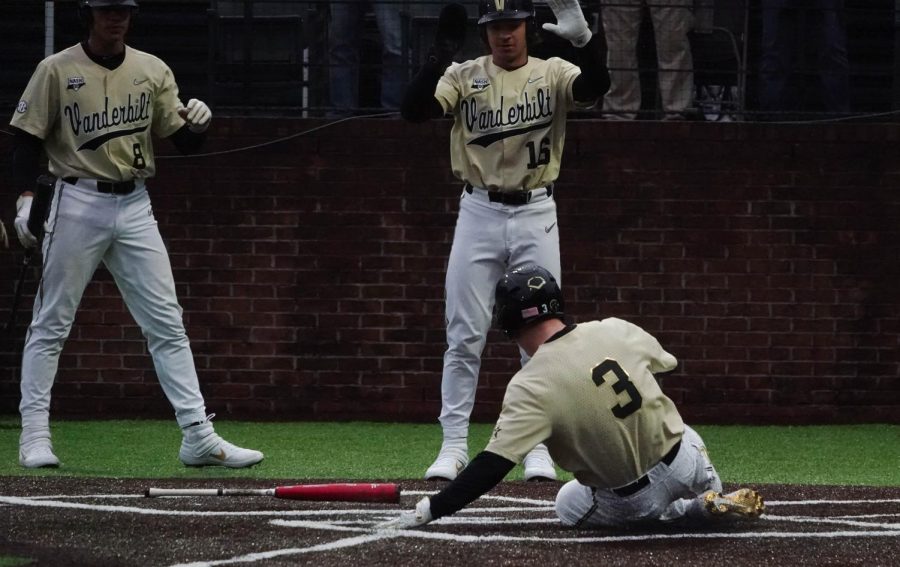 Cooper Davis (3) slides home. 