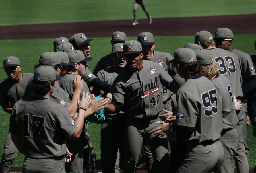 Christian Little meets his teammates after pitching a scoreless sixth inning on Sunday. (Hustler Multimedia/Barrie Barto)