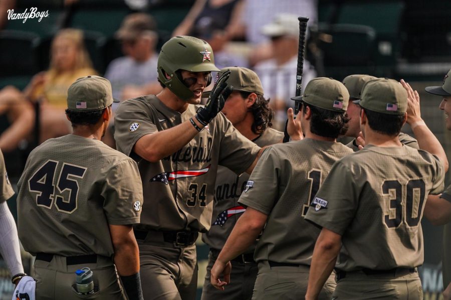Spencer Jones celebrates scoring a run against Texas A&M with his teammates on Saturday, April 30, 2022.