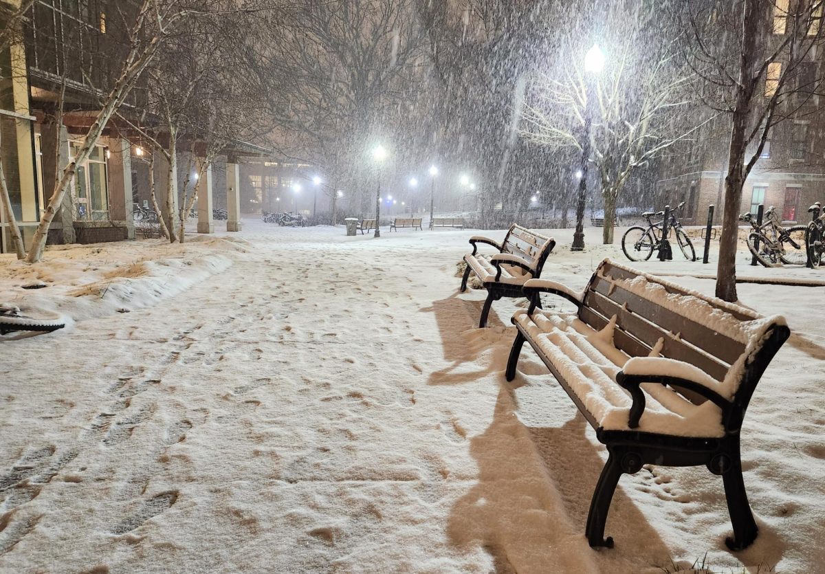Benches in front of the Kissam Student Center on a snowy evening, as photographed on Jan. 14, 2023. (Hustler Multimedia/Alice Tang)