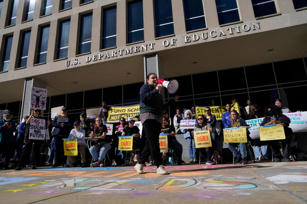 A demonstrator speaks through a megaphone during a Defend Our Schools rally to protest U.S. President Donald Trump's executive order to shut down the U.S. Department of Education, outside its building in Washington, D.C., U.S., March 21, 2025. REUTERS/Kent Nishimura